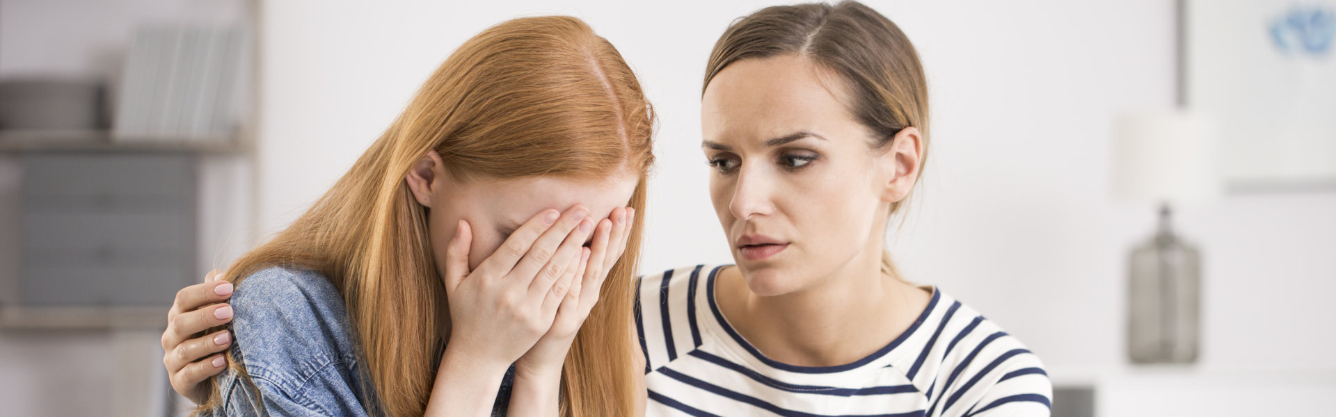 a psychologist comforting a crying girl